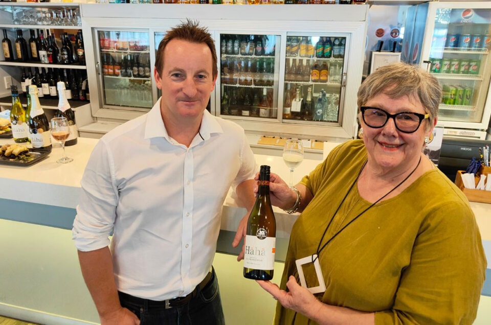 Two people standing in front of a wine bar